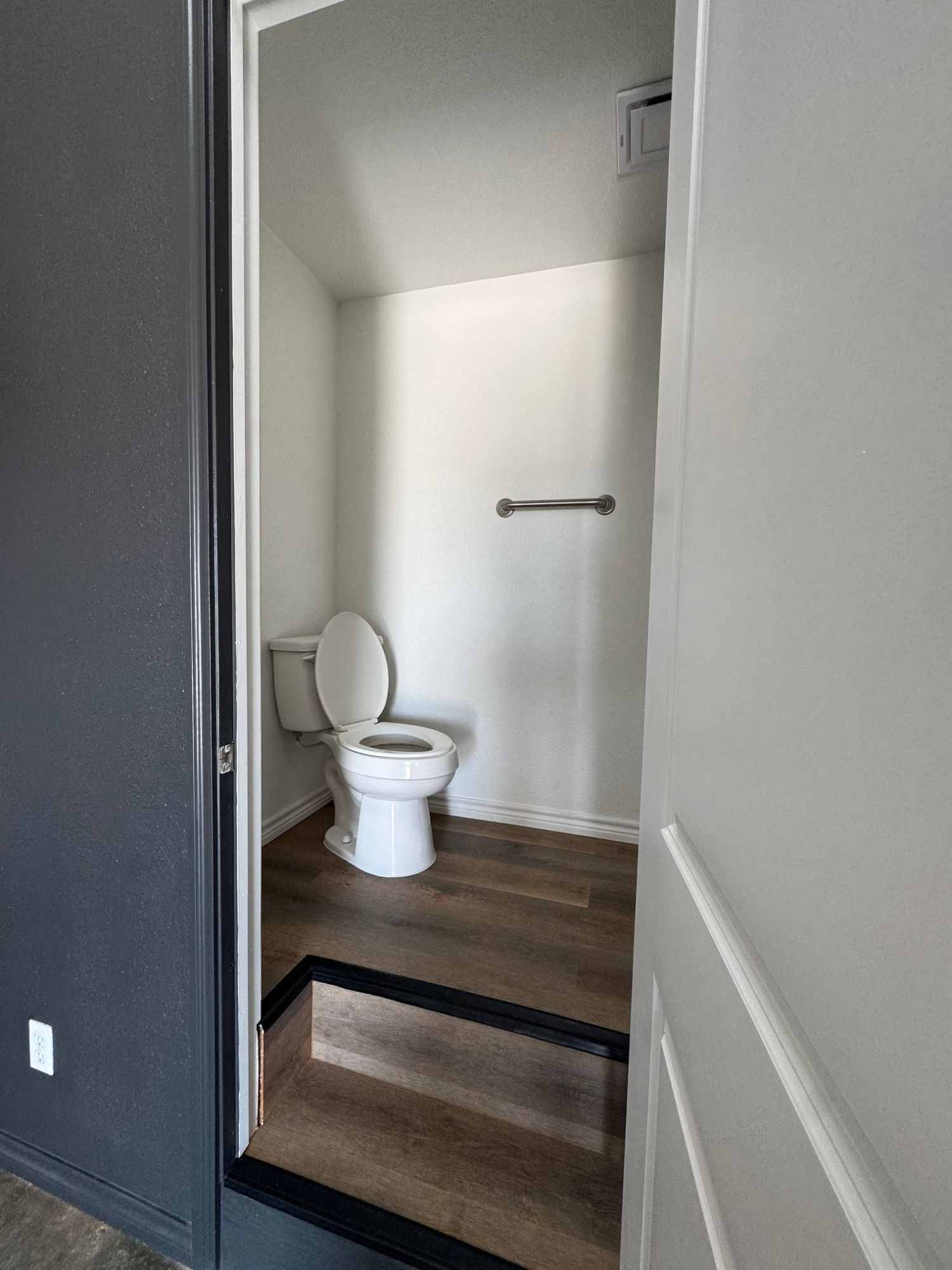 Private bathroom with grab bar in a dome unit at The Domain