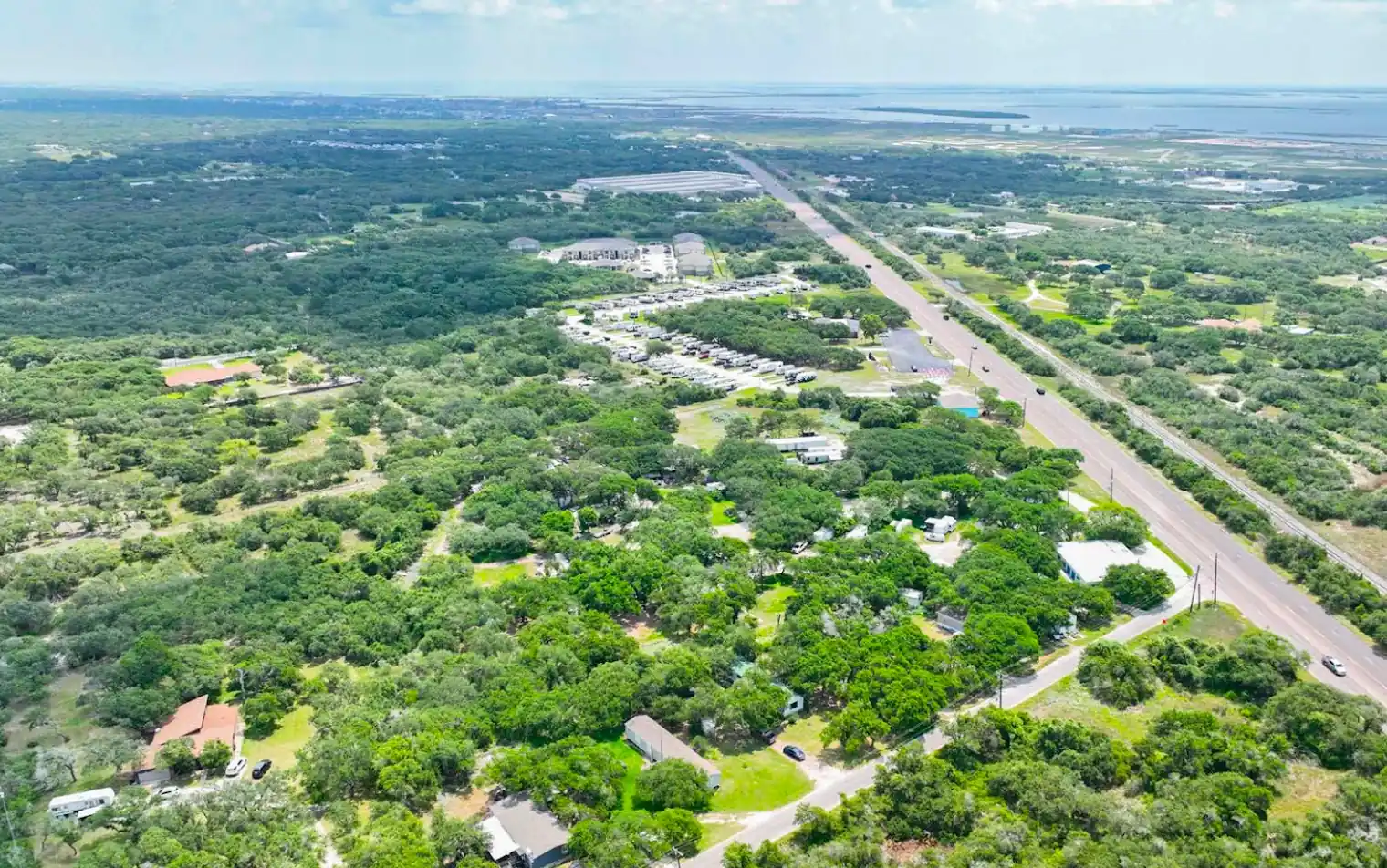 Indian Trails RV Park under live oaks beside Highway 361 in Ingleside, Texas, looking toward the bay